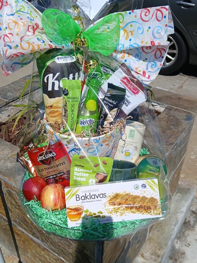 Gourmet gift basket with baklava, fruit, and snacks