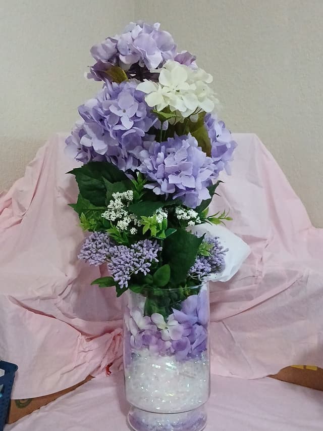 Lavender and white hydrangea arrangement in a glass vase