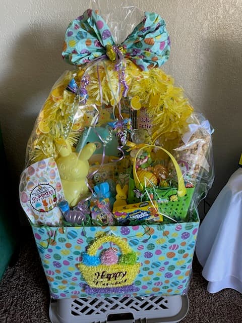 Large Easter gift basket with a yellow bow and toys